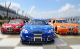 Red, blue, and orange stock cars crossing finish line