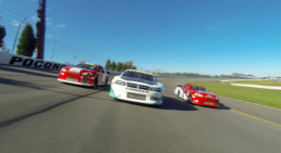 Three stock cars racing at Pocono Raceway